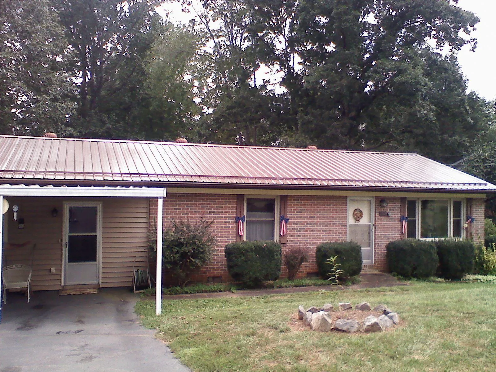 Bronze metal roof and carport on a brick ranch home — Roof Repair work by our crew in Eden Prairie